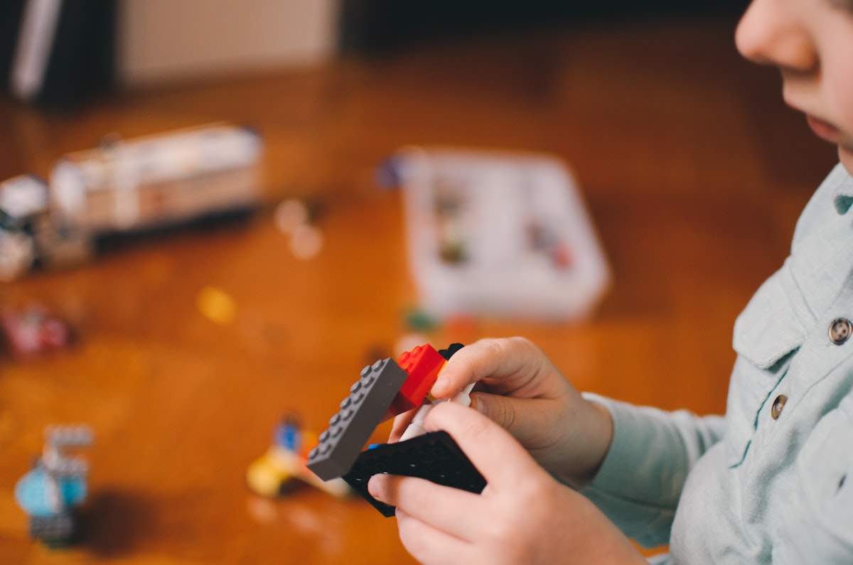 A toddler exploring wooden blocks at home.